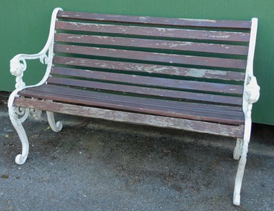 Lot 565 - A garden bench, with white painted cast iron...