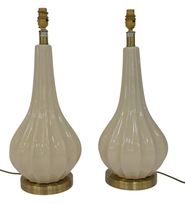 Lot 577 - A pair of cream glazed pottery table lamp...