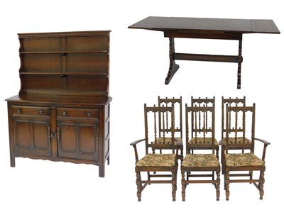 Lot 634 - An Ercol Old Colonial dining room suite,...