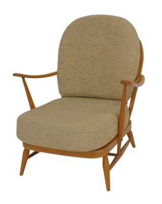 Lot 640 - An Ercol light elm open armchair, with loose...