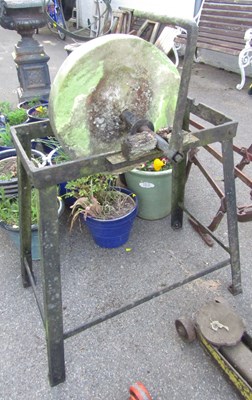 Lot 1144 - A metal framed grinding stone, with handle.
