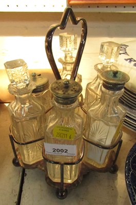 Lot 2002 - A silver plated six bottle cruet set.
