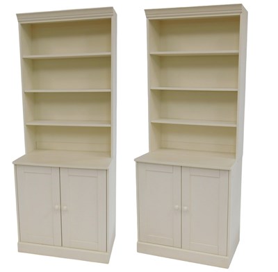 Lot 697 - A pair of cream painted bookcases, each with a...