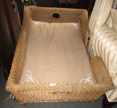 Lot 1154 - A wicker dog basket, with fleece...