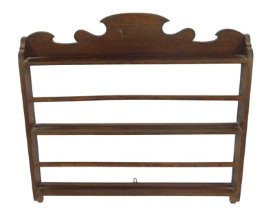 Lot 712 - A late 19thC oak wall hanging rack, the shaped...