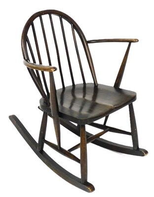 Lot 227 - A mid century Ercol beech and elm rocking...