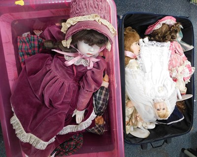 Lot 2156 - A suitcase containing dolls, another box...