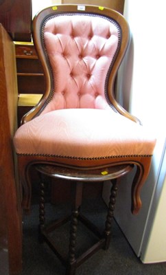 Lot 1028 - A nursing chair, upholstered in pink fabric,...
