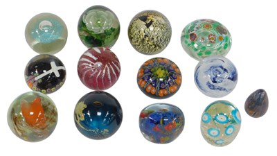 Lot 517 - A group of glass paperweights, including...