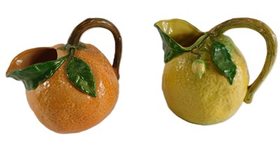 Lot 158 - Two relief moulded jugs, decorated as an...