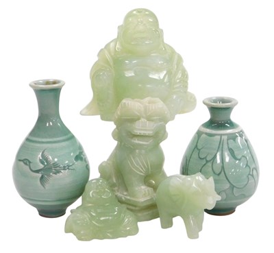 Lot 52 - Two jade figures of a seated Buddha, a further...