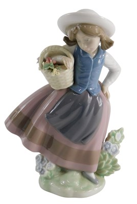 Lot 234 - A Lladro porcelain figure of a lady holding a...