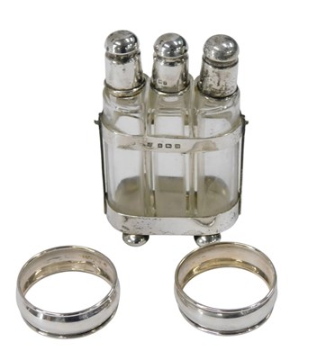Lot 295 - A silver scent bottle holder, with three...