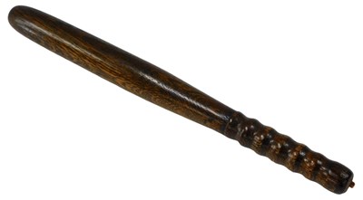 Lot 323 - A turned oak policeman's truncheon, 42cm long.