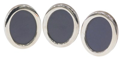 Lot 324 - Three modern oval silver mounted photograph...
