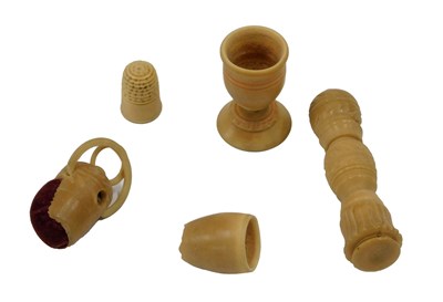 Lot 392 - A 19thC carved coquilla nut needle case,...