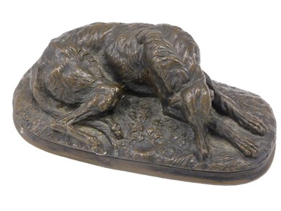 Lot 401 - A bronze resin sculpture of a recumbent...