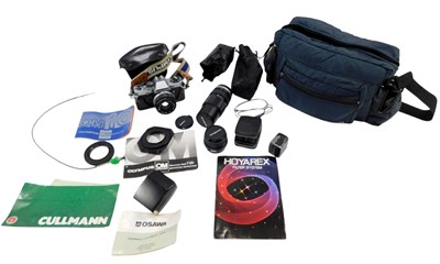 Lot 451 - An Olympus OM10 camera, with lens, an Olympus...