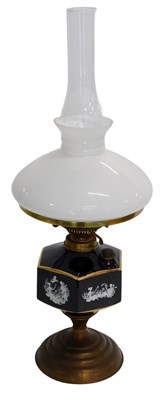 Lot 654 - A late 19th/early 20thC oil lamp, with a milk...
