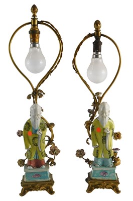 Lot 22 - A pair of Continental porcelain lamp...
