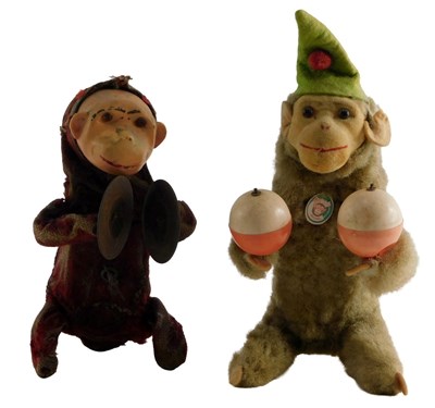 Lot 595 - A tinplate model of a monkey playing symbols,...