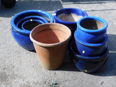 Lot 799 - A set of three circular blue glazed pottery...