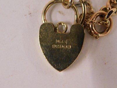 Lot 84 - A 9ct rose gold graduated curb link bracelet,...