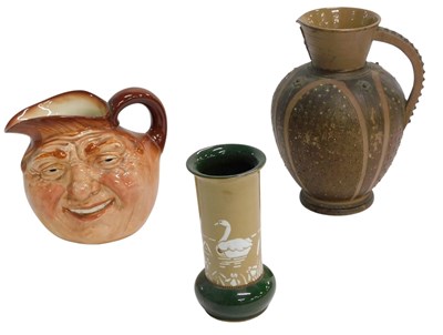Lot 670 - A Doulton silicon vase, with mask below the...