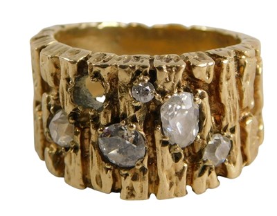 Lot 71 - A 9ct gold and diamond ring, in a textured...