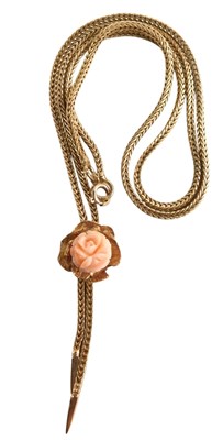 Lot 100 - A 9ct gold and coral pendant necklace, carved...