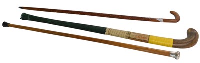 Lot 699 - A vintage hockey stick, applied with label...