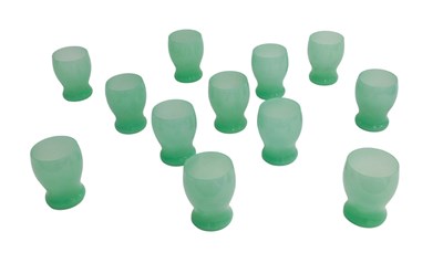 Lot 705 - A set of twelve green opaque glass beakers, in...