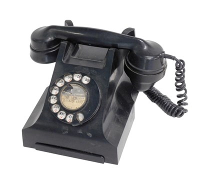 Lot 712 - A vintage black Bakelite telephone, with drawer.