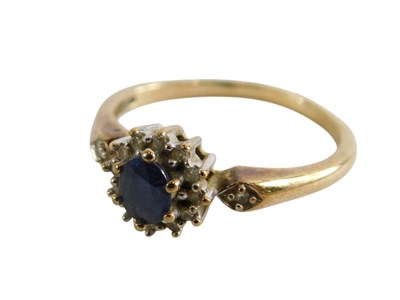Lot 345 - A 9ct gold sapphire and diamond ring, the oval...