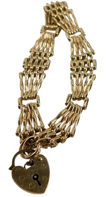 Lot 343 - A 9ct gold bracelet, on a heart shaped padlock...