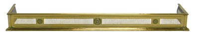 Lot 812 - A pierced brass fender, 131cm wide.