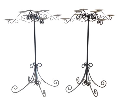 Lot 850 - A pair of black painted wrought iron candle...