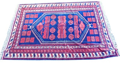 Lot 938 - A Turkish red ground rug, with central...