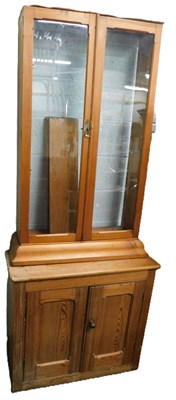 Lot 916 - A pine wall cupboard, with two glazed doors,...
