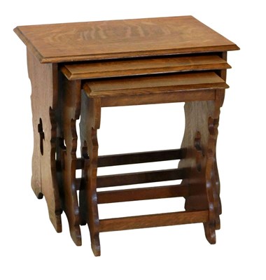 Lot 906 - An oak nest of occasional tables, carved...