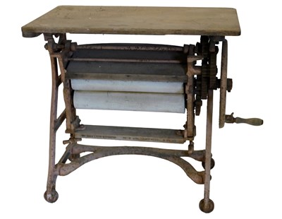 Lot 909 - A pine and cast iron mangle, raised on cast...