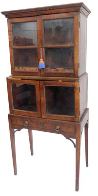 Lot 867 - A walnut cabinet, in three parts, the top with...