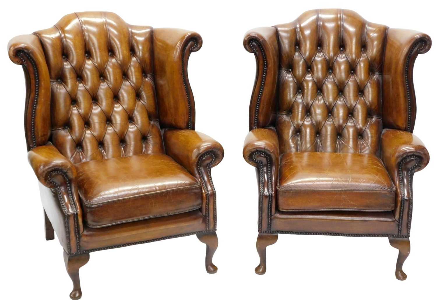 Lot 36 - A pair of brown leather Chesterfield wingback...