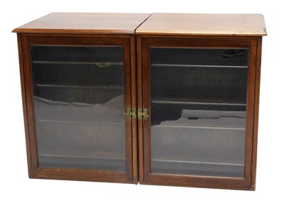 Lot 876 - A pair of mahogany cabinets, each with a...