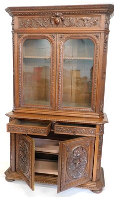 Lot 903 - A late Victorian oak cupboard bookcase,...