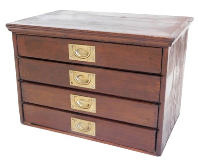 Lot 882 - A 20thC stained pine collectors chest, of four...