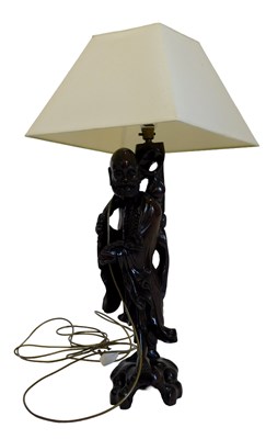 Lot 784 - An Oriental hardwood lamp base, carved with a...