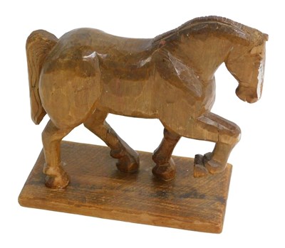 Lot 750 - A folk art carving of a horse, on a...
