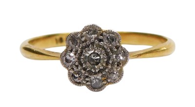 Lot 104 - A diamond flower head ring, set with nine...