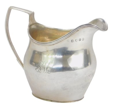 Lot 19 - A George III silver helmet shaped cream...